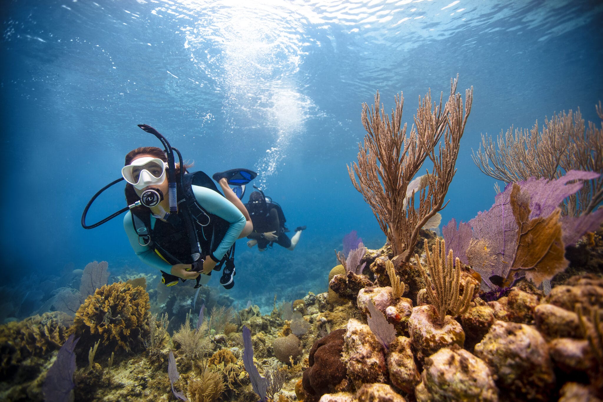 Diver exploring the coral reef formations off of the coast of the Pacific Ocean in Playa Potrero Bay